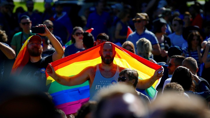 A ‘Yes’ campaign supporter holds a rainbow flag at a rally after it was announced that a majority of Australians support legalizing same-sex marriage at a rally in Sydney, Australia on November 15, 2017.