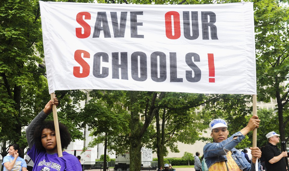 Students of the East Ramapo School District hold a sign that reads "Save our schools!" 