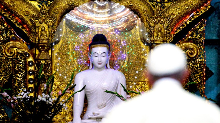 Pope Francis walks toward a statue of the Buddha during a meeting with the state Sangha Maha Nayaka Committee in Burma on November 29, 2017.