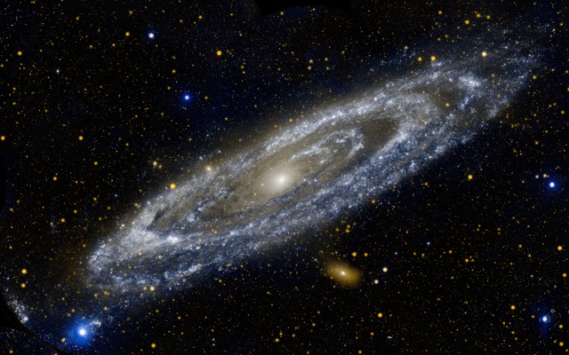 A person's hands twirl a fidget spinner.