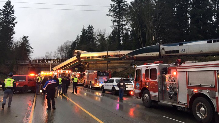 Firefighters and police on the scene of a trail derailment