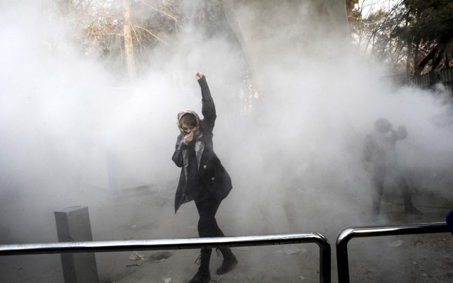 Students attend a protest at Tehran University, where a smoke grenade was thrown by anti-riot Iranian police on December 30, 2017.