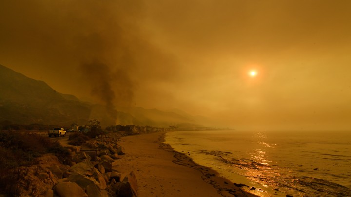 Heavy smoke covers the seaside enclave of Mondos Beach north of Los Angeles, California from wildfires in the region