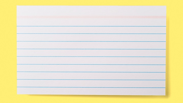 A lined index card on a yellow background