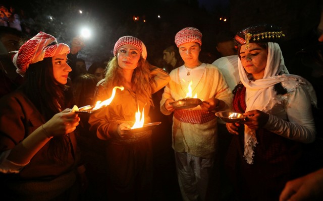 Yezidis light candles and paraffin torches during a ceremony to celebrate the New Year in Dohuk province, Iraq, in 2017.