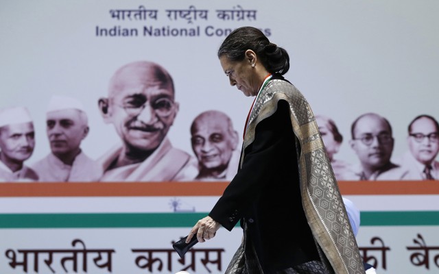 Sonia Gandhi walks to address her party workers at the All India Congress Committee meeting in New Delhi on January 17, 2014. 