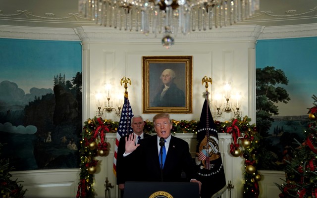 Donald Trump, flanked by Vice President Mike Pence, delivers remarks.