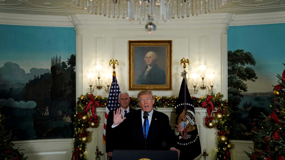 Donald Trump, flanked by Vice President Mike Pence, delivers remarks.