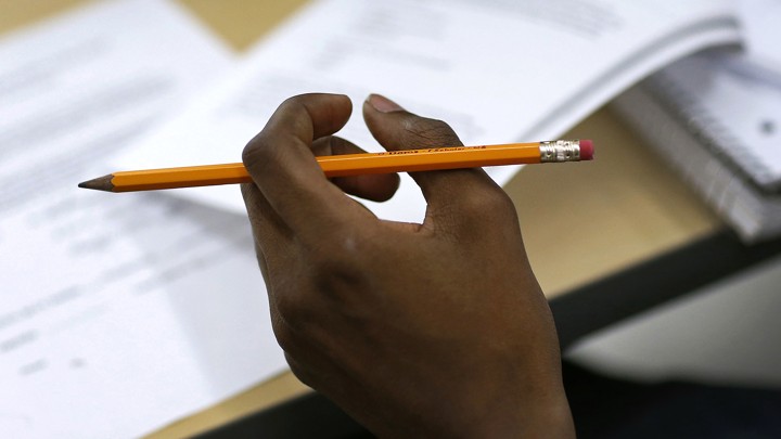 A hand holds a pencil