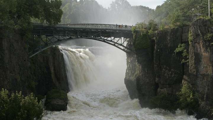 A swollen river under a bridge