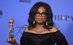 Oprah Winfrey stands with her Golden Globes award.
