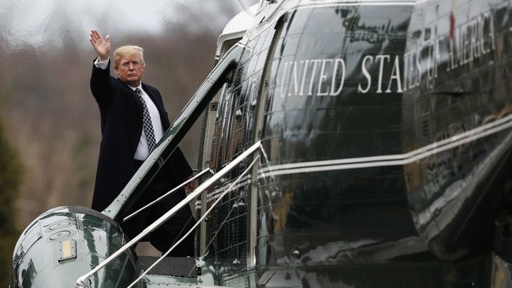 President Trump, waving, boards Marine One.