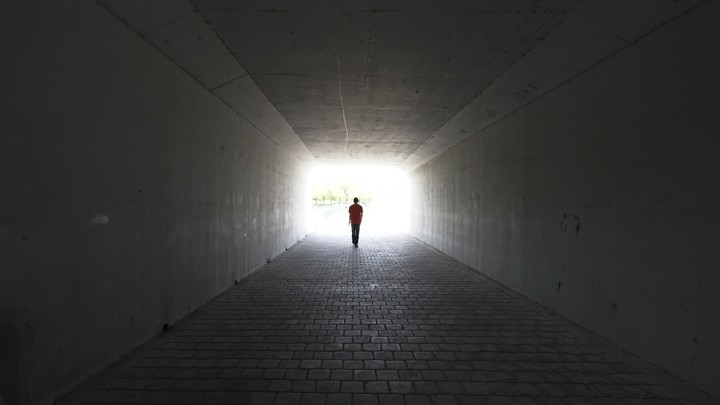 A person walks out of a tunnel