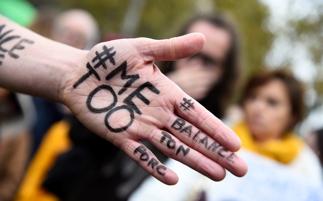 A picture shows the messages '#Me too' and #Balancetonporc ('expose your pig') on the hand of a protester. 