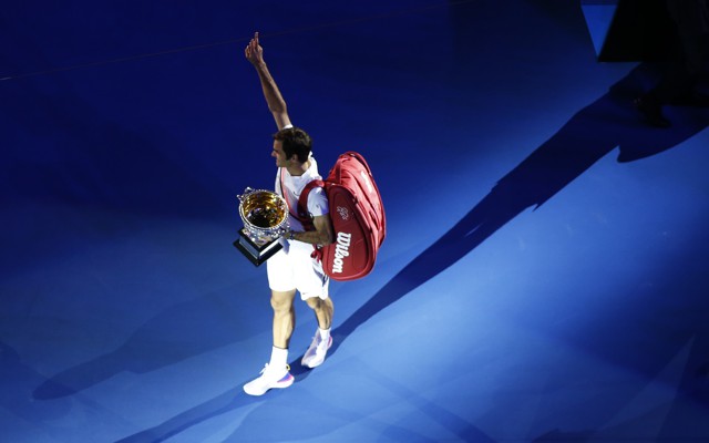 After the Australian Open men's singles finals, the winner Roger Federer of Switzerland celebrates with the trophy