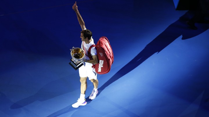 After the Australian Open men's singles finals, the winner Roger Federer of Switzerland celebrates with the trophy