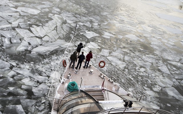 A boat moves through icy waters.