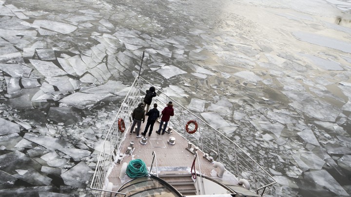 A boat moves through icy waters.