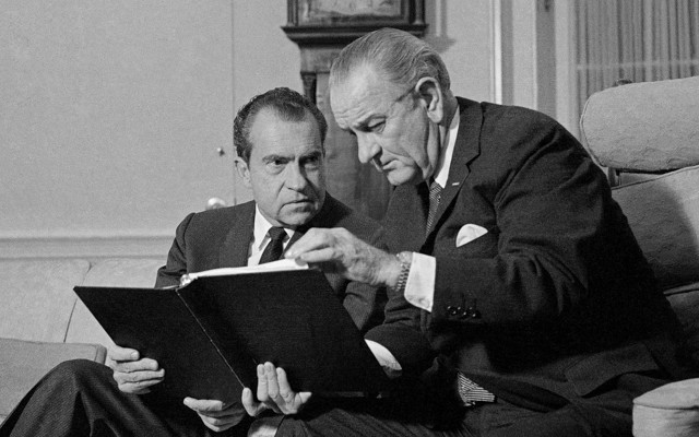 Lyndon B. Johnson and Richard Nixon speak in the Oval Office.