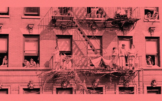 An antique photo of families and children looking out windows and standing on a fire escape