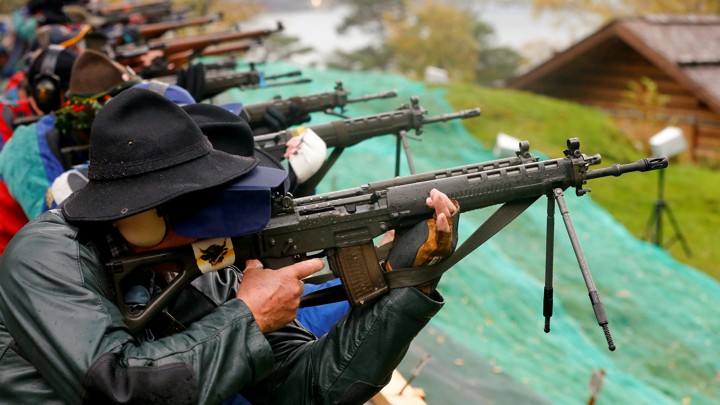 Several shooters aim their weapons at targets