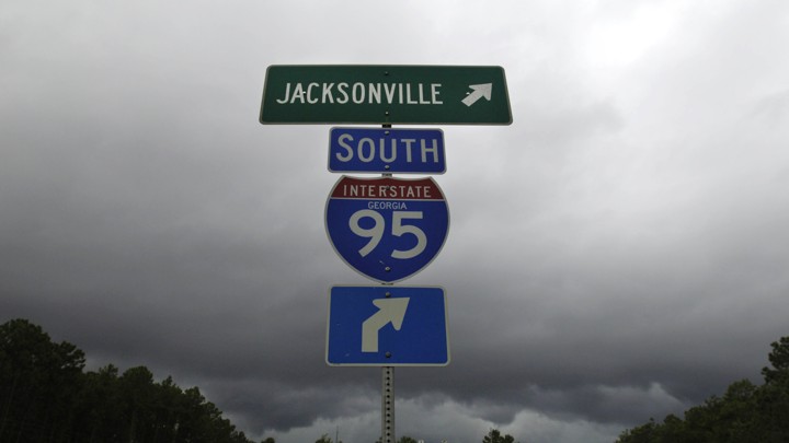 Blue and green I-95 interstate signs on a stormy day