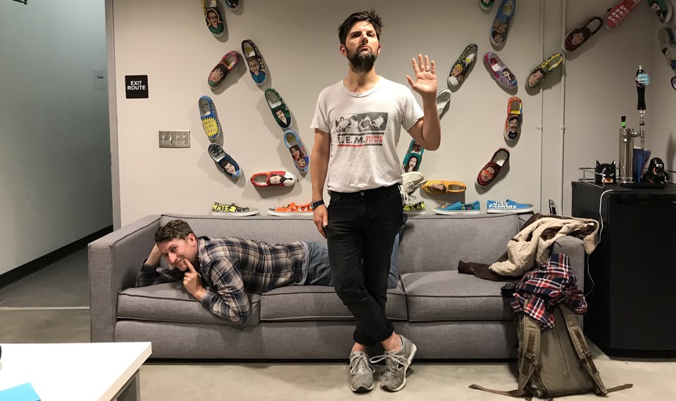 Adam Scott and Scott Aukerman posing in the studio where they record the podcast 'R U Talkin' R.E.M. Re: Me?'