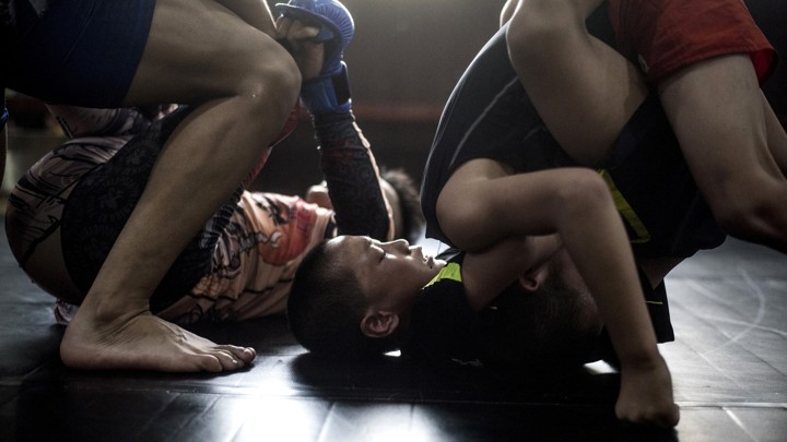 Boys are seen fighting.