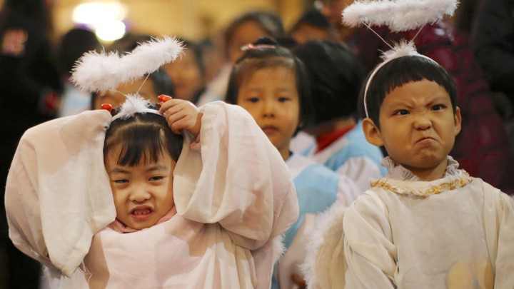 Children dressed as angels attend a Christmas mass at a Catholic church in Beijing.
