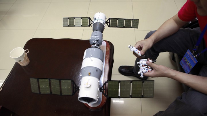 A model replica of the Tiangong-1 space station and three astronaut figures