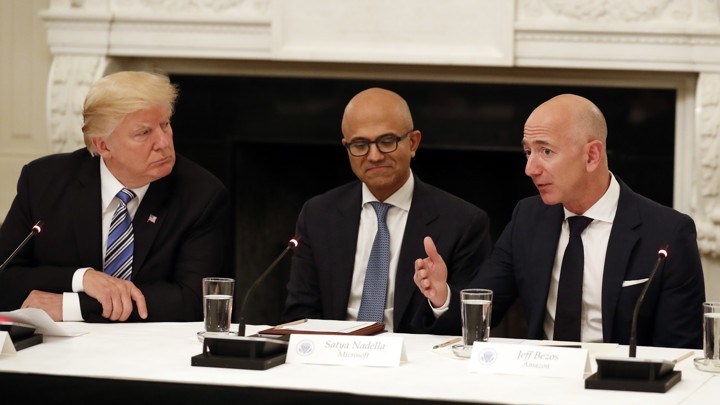 Donald Trump, Satya Nadella, and Jeff Bezos seated at a table