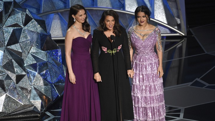 Ashley Judd, Annabella Sciorra, and Salma Hayek onstage at the 90th Academy Awards ceremony