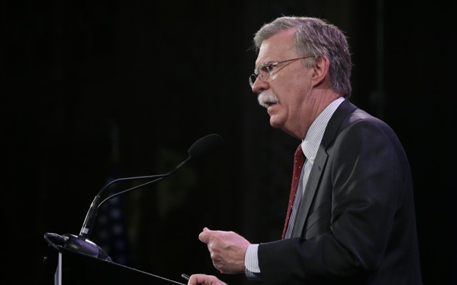 John Bolton speaks at a microphone.