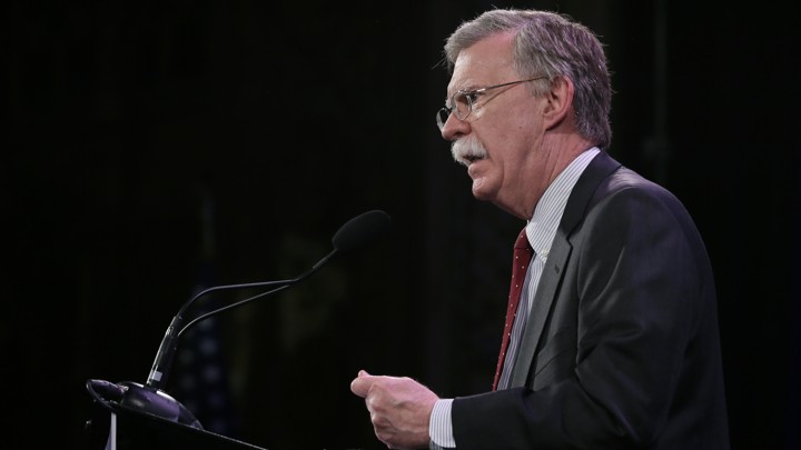 John Bolton speaks at a microphone.