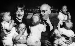 Dr. Spock smiling at many babies