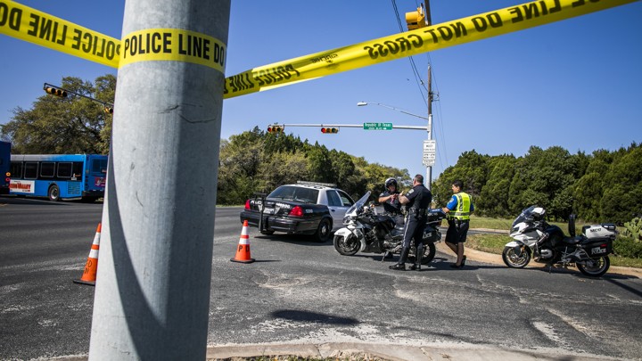Police tape marks off a neighborhood street in Austin, Texas.