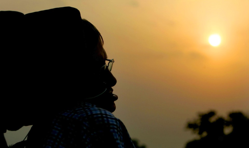 A silhouette of Stephen Hawking against a sunset