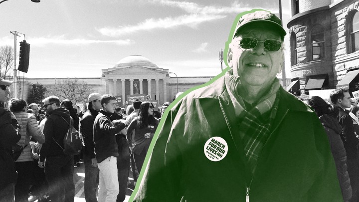 A man wearing a "March for Our Lives" pin, surrounded by a crowd in front of the National Gallery of Art
