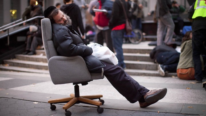 A protestor affiliated with the Occupy Wall Street movement falls asleep in an armchair in Foley Square in 2011.