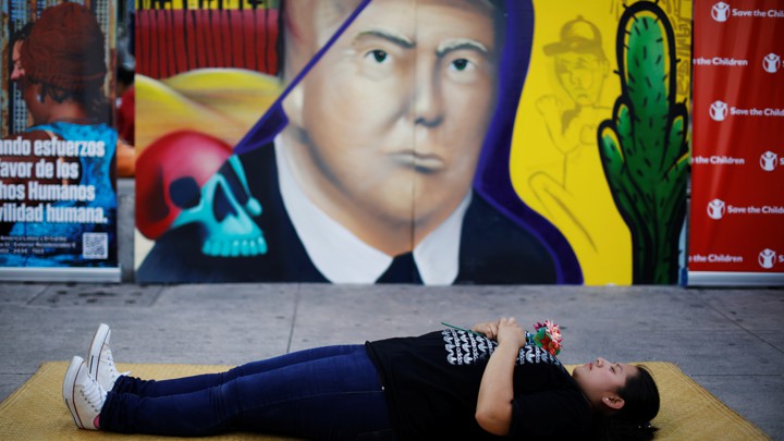 A woman pays homage to undocumented migrants from El Salvador and their journey to the U.S.