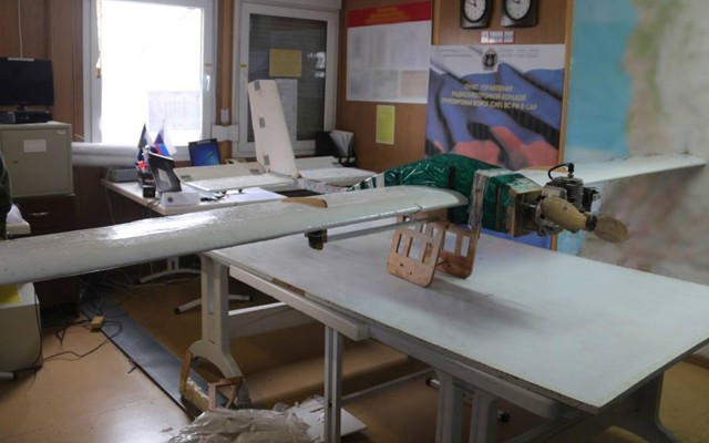 A drone rests on a table in an office.