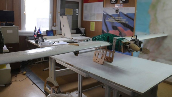 A drone rests on a table in an office.