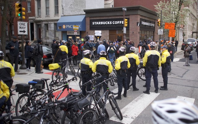 Police stand outside of a Starbucks. 