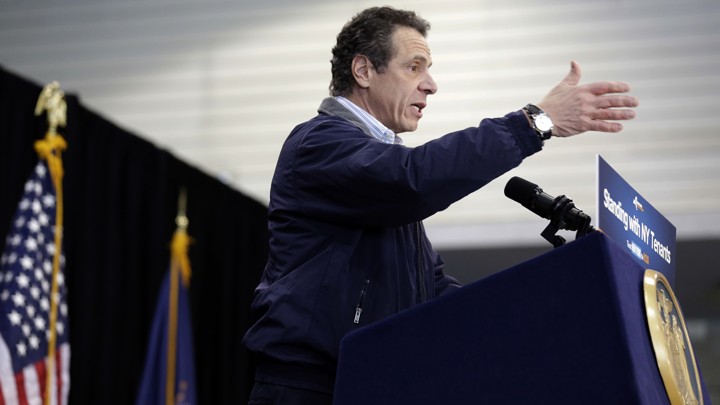 New York Governor Andrew Cuomo giving a speech at a lectern