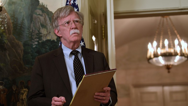 John Bolton holding a legal pad