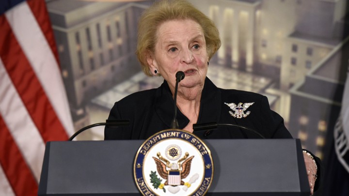Madeleine Albright stands at a Department of State podium.