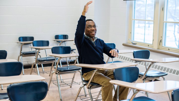 Donald Richards seated at a desk in a classroom
