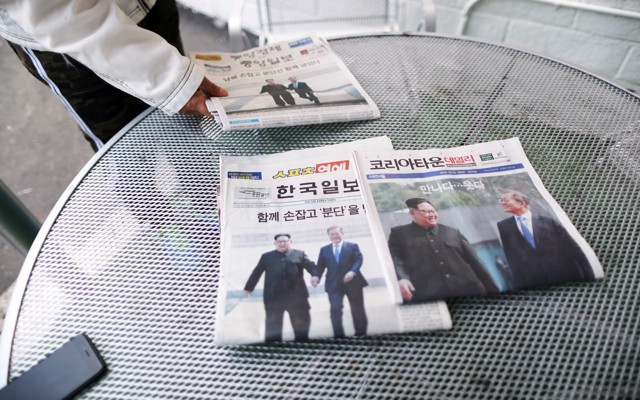Korean newspapers on a table showing Presidents Kim and Moon together