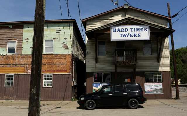 A rustic building with a sign that says "Hard Times Tavern"