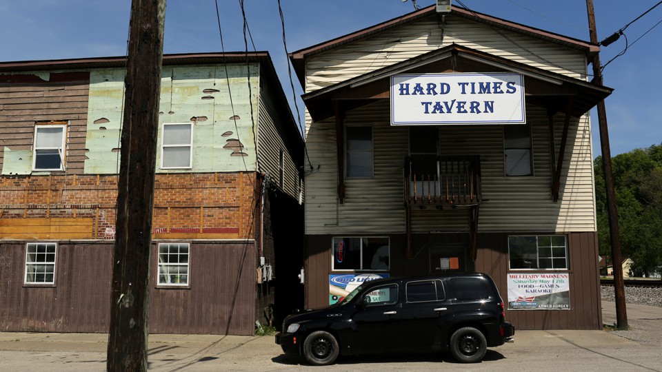 A rustic building with a sign that says "Hard Times Tavern"